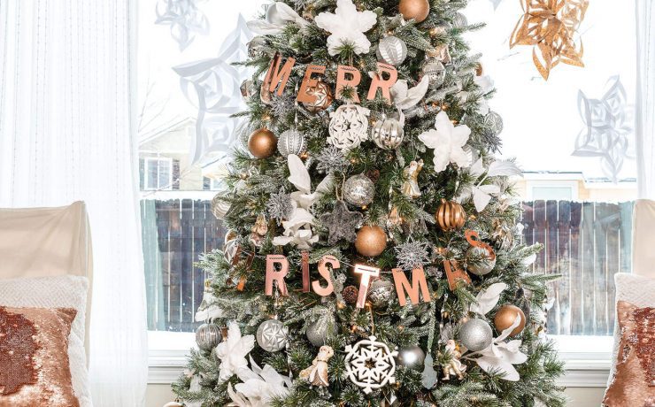 Silver and gold metallic Christmas tree with giant paper snowflakes