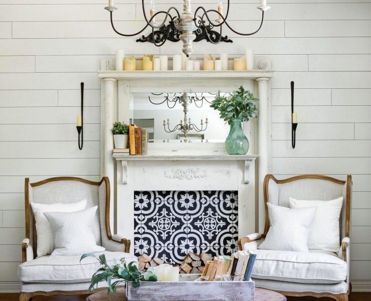 A classic white mantelpiece. Instead of a fire, the mantel sports a blue and white tiling with a unique pattern
