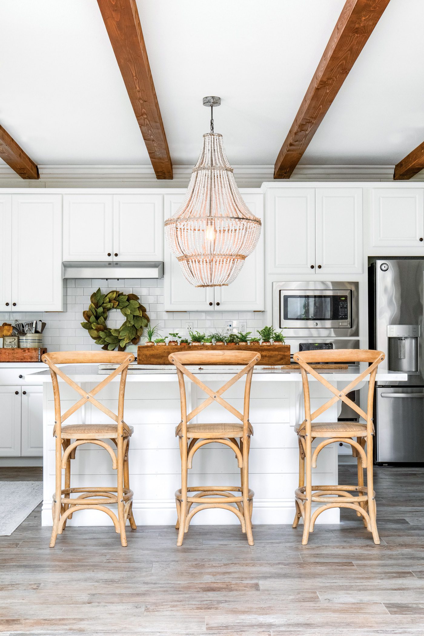 White farmhouse kitchen with sugar mold centerpiece on island