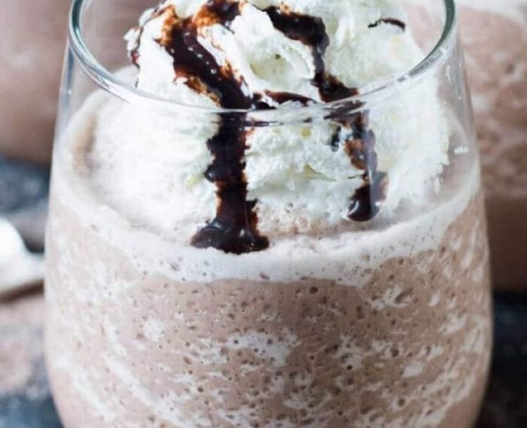 Frozen hot chocolate with chocolate syrup in a glass cup