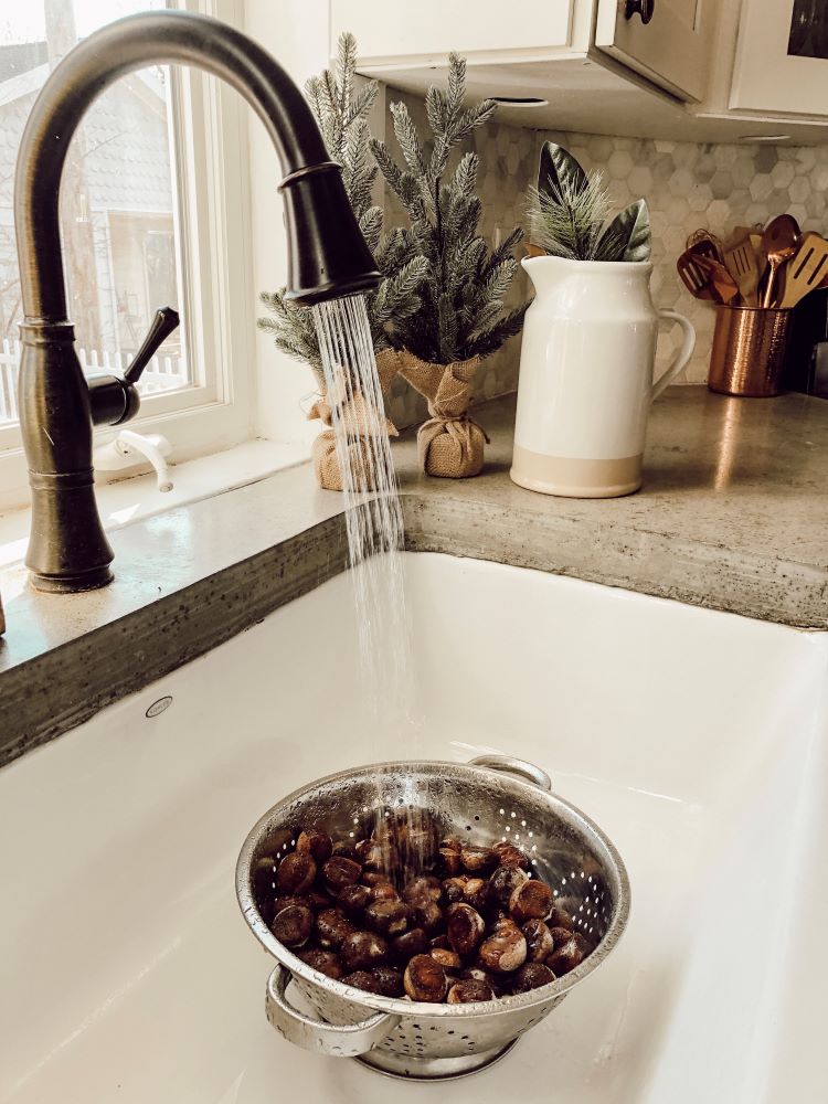 Rinsing chestnuts in a farmhouse sink