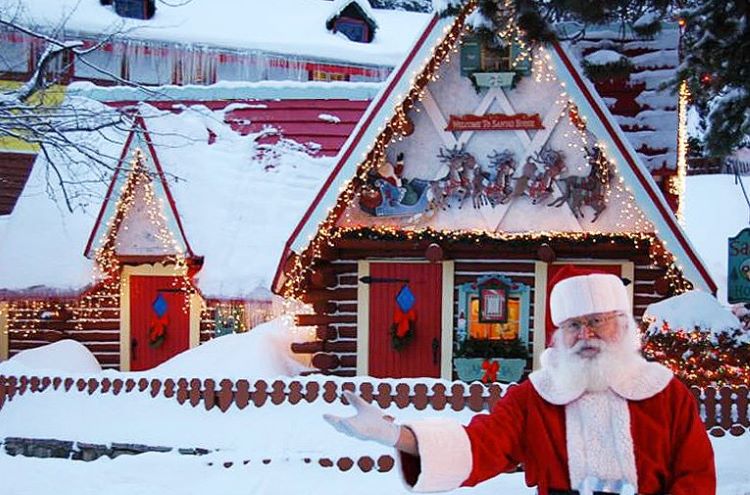 Santa stands in front of his house in North Pole, New York