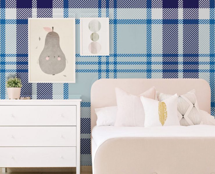Blue plaid wallpaper in a bedroom with white furniture.