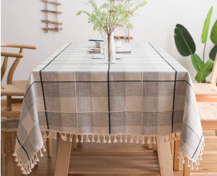 Neutral-colored plaid tablecloth with tassels.