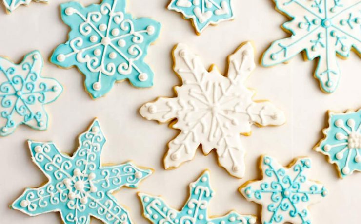 Iced sugar cookies in delicate baby blue and white frosting swirls