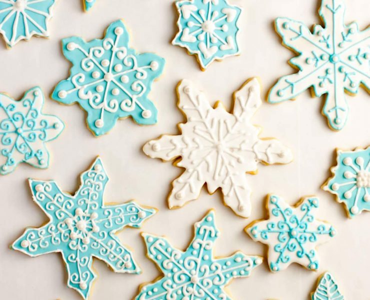 Iced sugar cookies in delicate baby blue and white frosting swirls