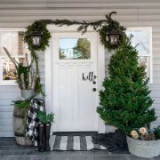 Front porch at Christmas time with tree and garlands