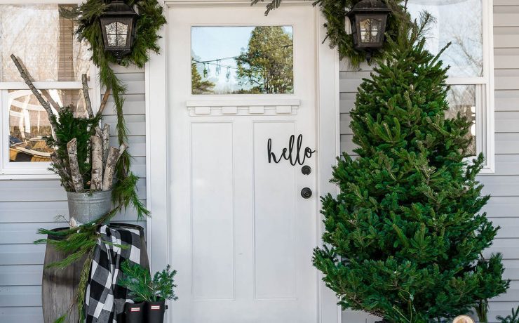 Front porch at Christmas time with tree and garlands