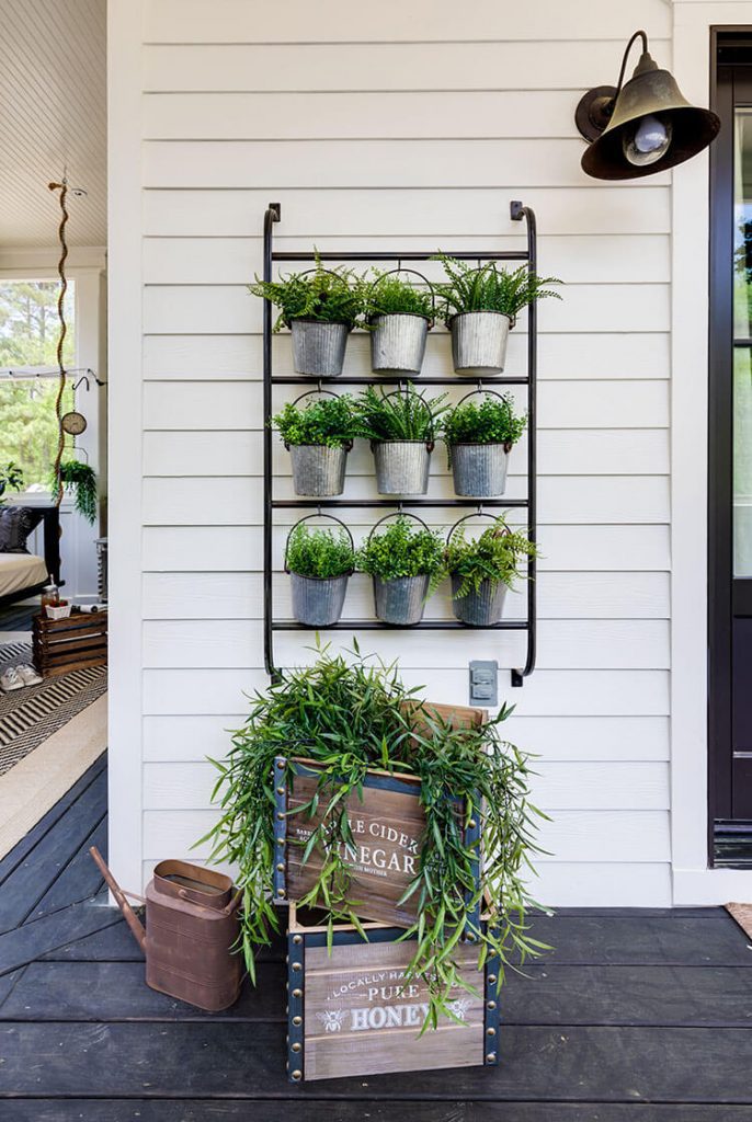 Porch design with hanging plants and crates