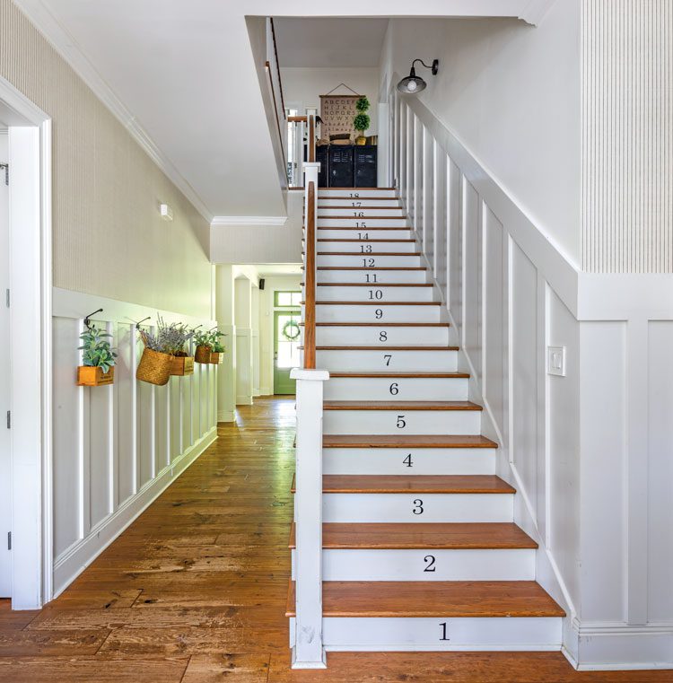 Back staircase in farmhouse with painted stair raisers
