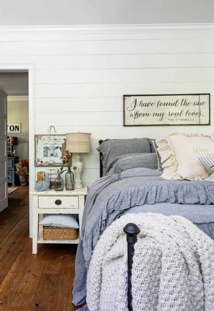 Master bedroom in Georgia farmhouse with gray ruffled bedding