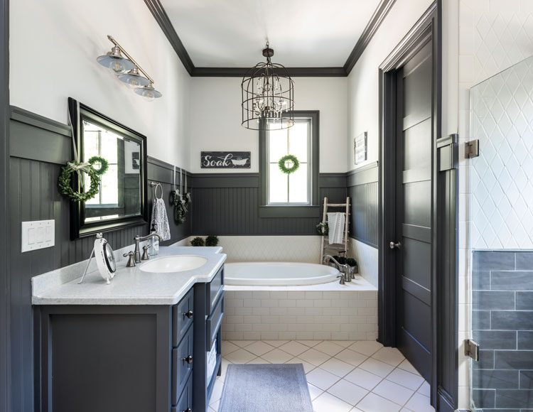 Master bathroom in Georgia farmhouse with black accents and white tile flooring