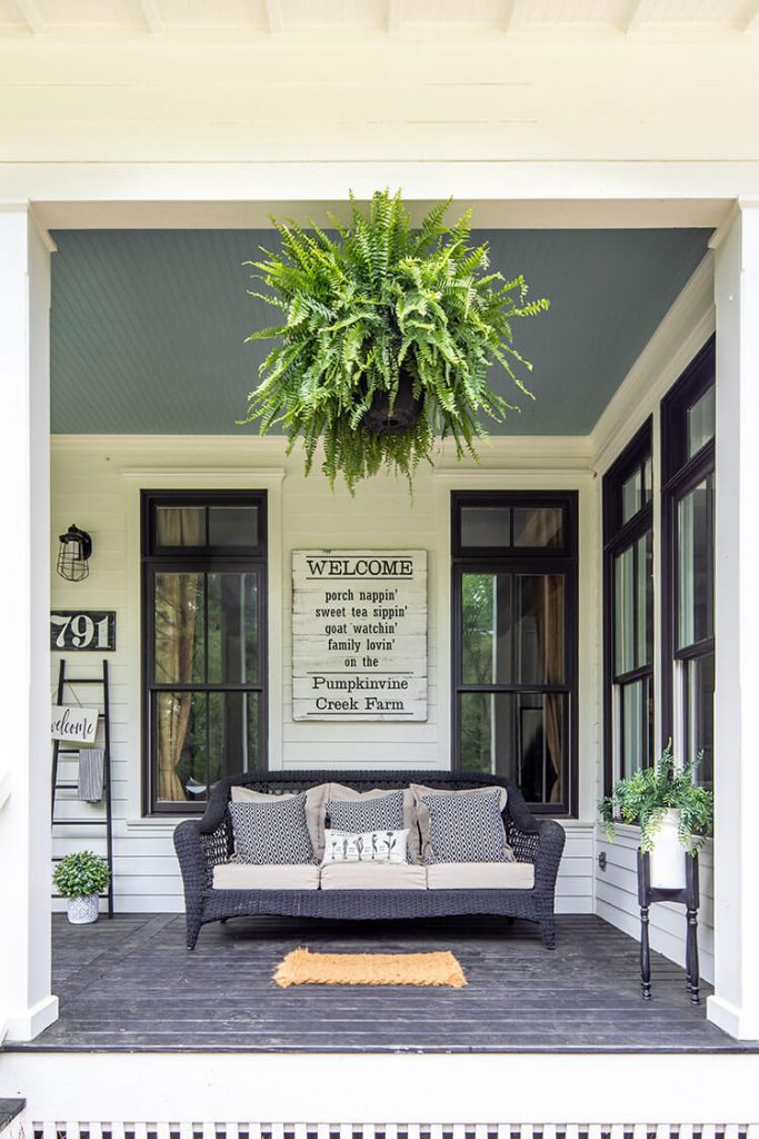 Front porch with Welcome sign and sofa