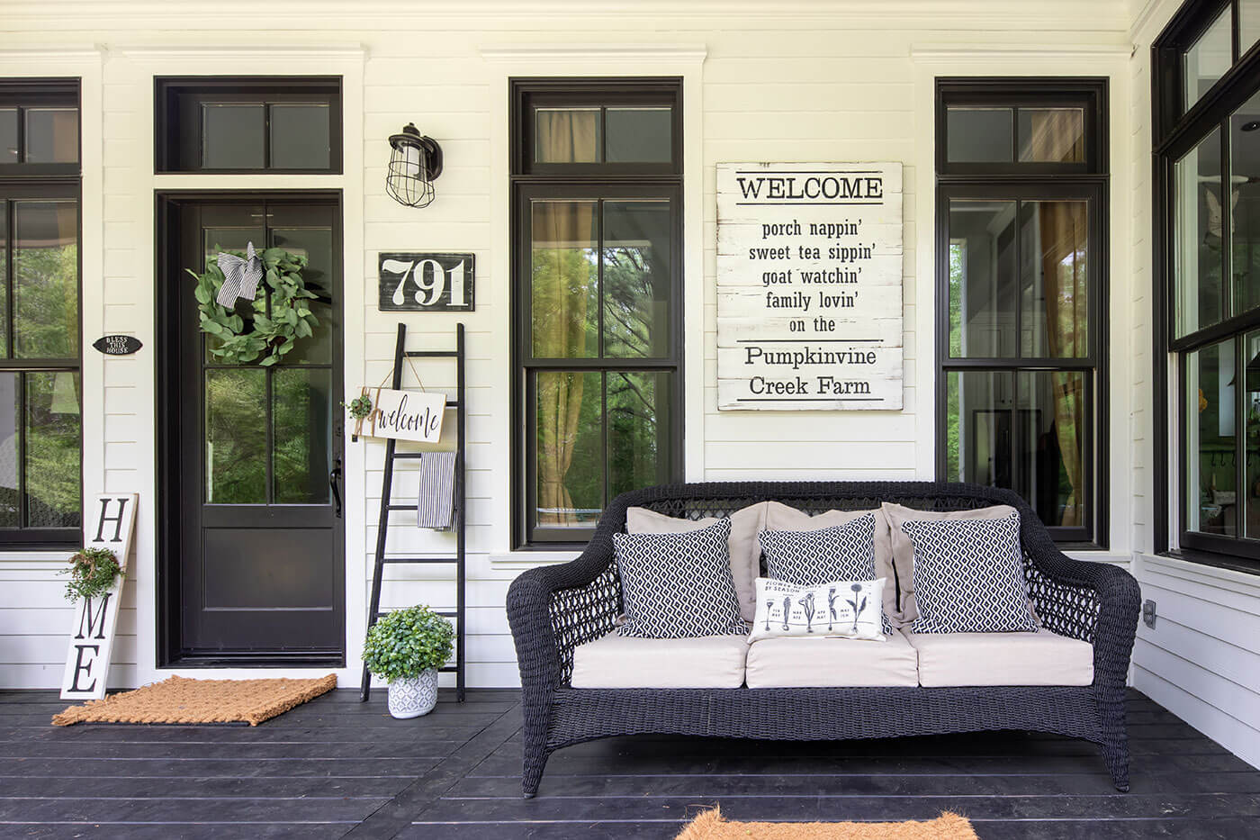 Farmhouse Georgia porch with sofa and sign art