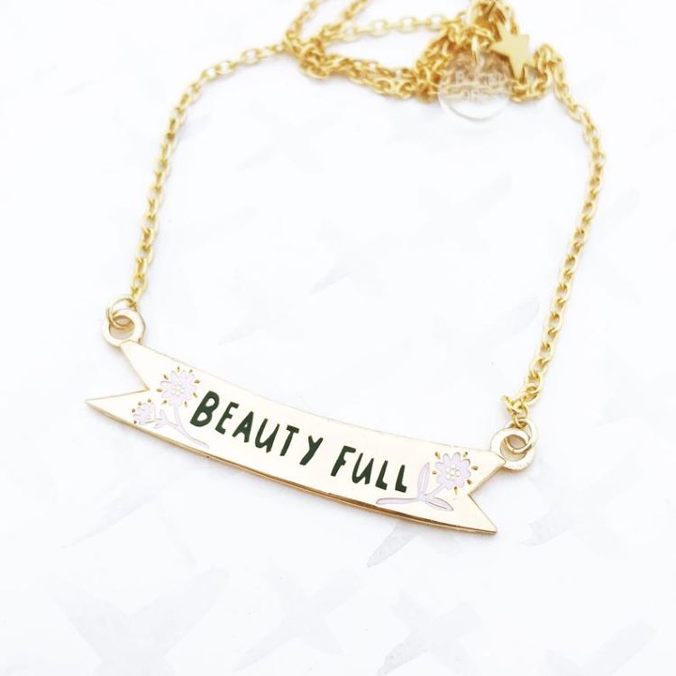A necklace with the words, "beauty full"