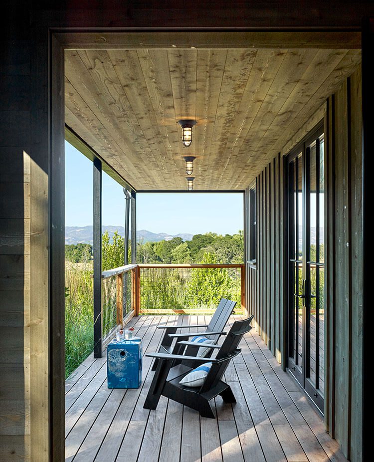 Outdoor patio with industrial lighting and outdoor seating area