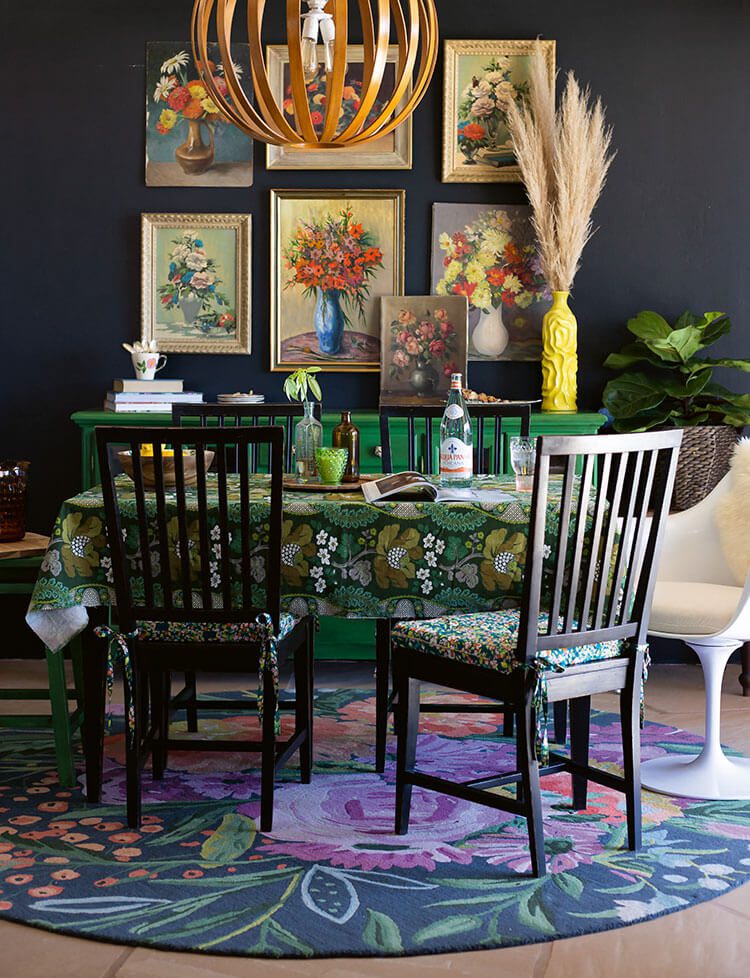 Dining room with vintage paintings and floral patterns on tablecloth