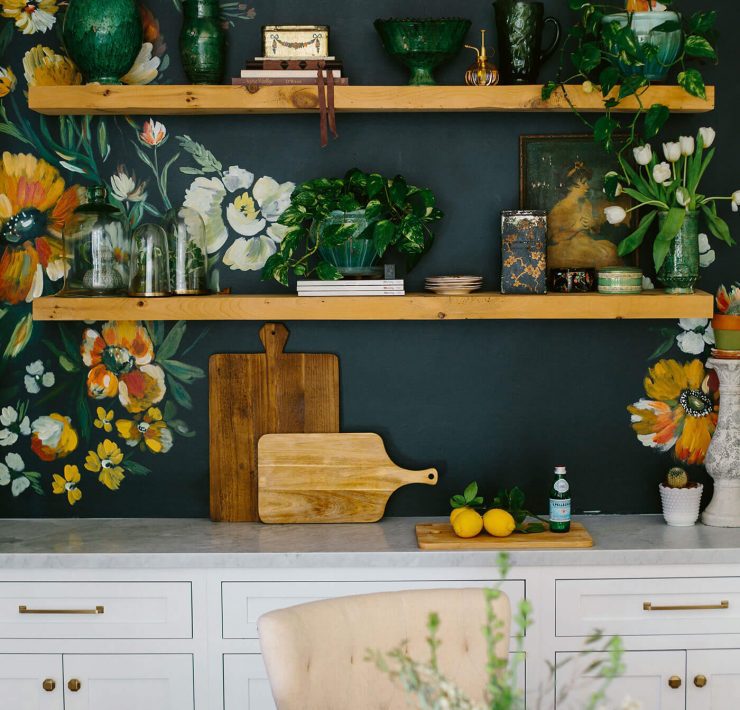 Kitchen with floral pattern on walls above open shelves