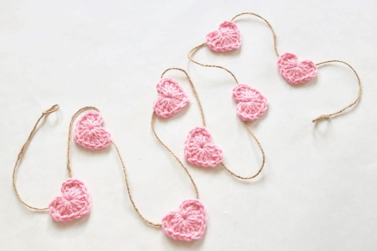 Baby pink crochet hearts work as a garland on a jute string
