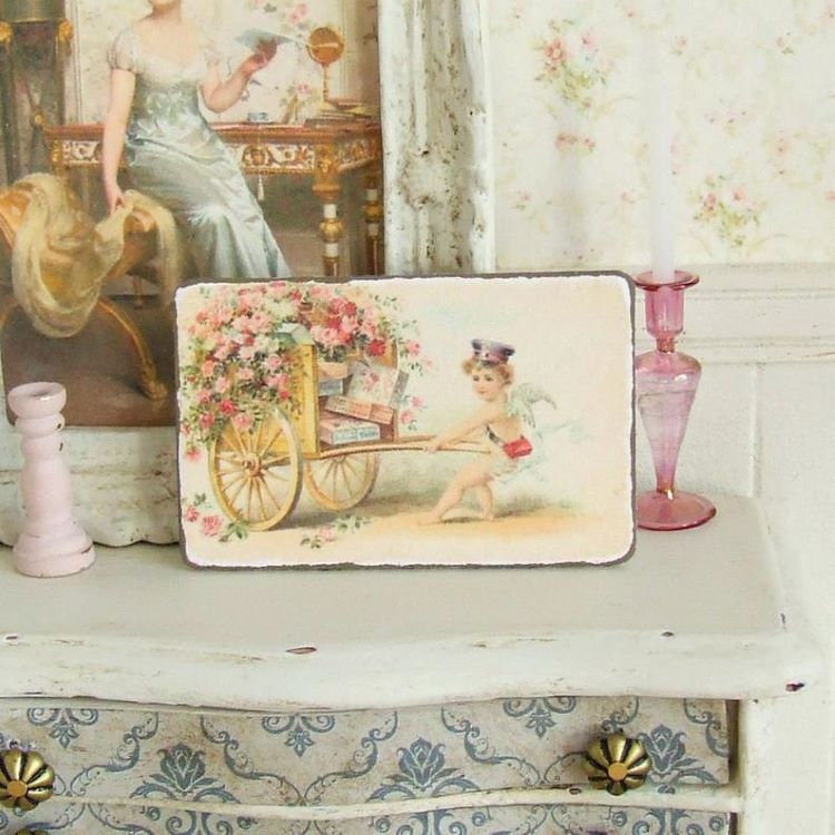 Petite art with an image of Cupid pullign a wagon full of love letters