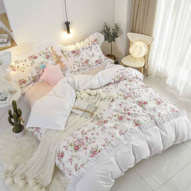 A puffy floral comforter set in a farmhouse style with ruffles and ruches