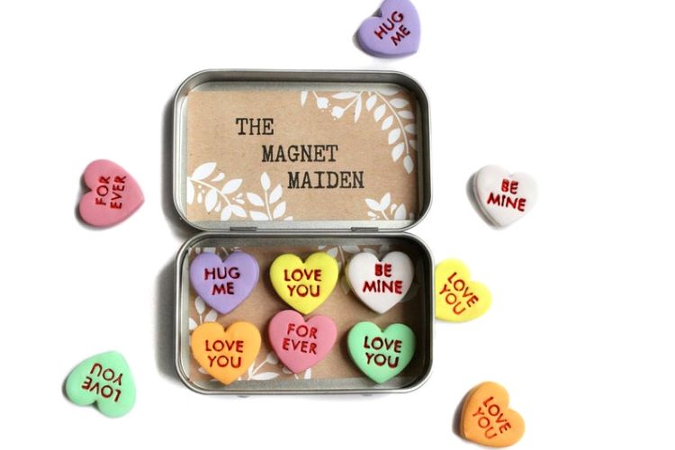 Magnets shaped like hearts in several shades and written to look like Valentine's Day conversation hearts