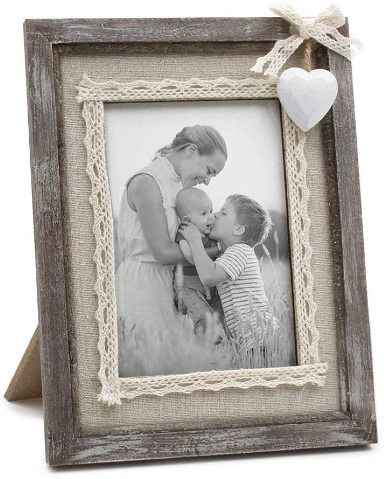 A rustic bare wood small picture frame with a small white porcelian heart in its corner