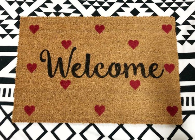 A door mat with hearts and the word, "welcome"