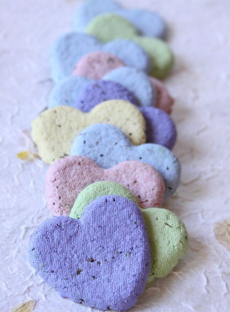 A row of heart shaped flower seed bombs in every shade of pastel color