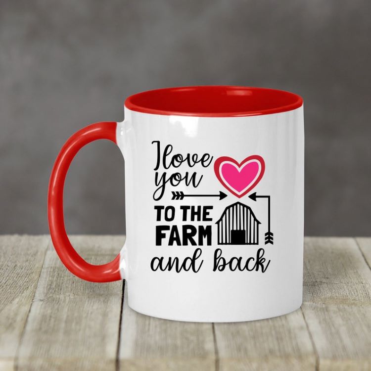 A white mug with a red handle. The mug says "I love you to the farm and back."