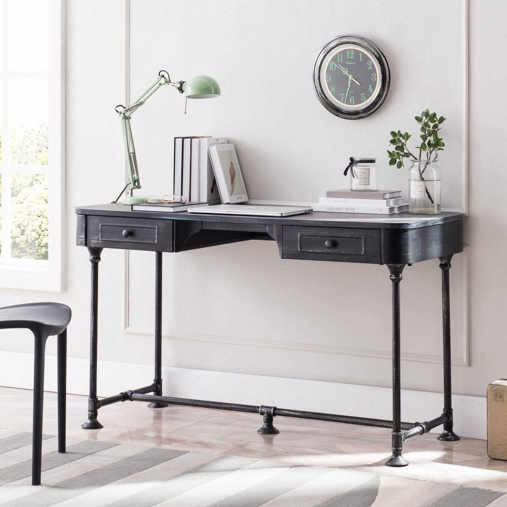 Metal writing desk with wall clock on the wall