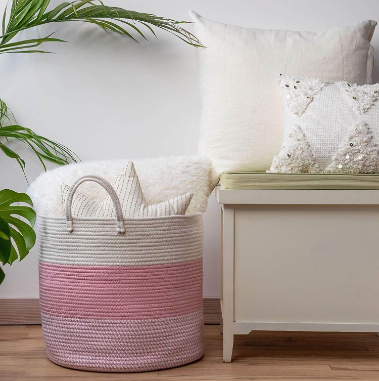 A large rope basket in a gradiant of pink shades