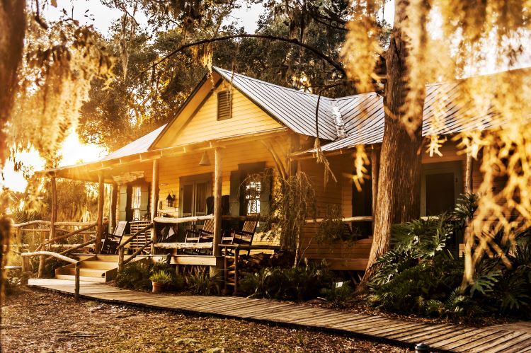 The building's esterior with a farmhouse style porch at dusk