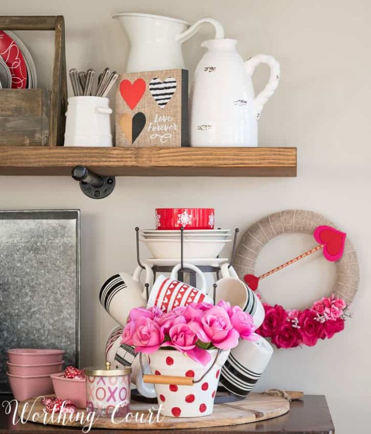 An assortment of burlap pieces with pops of pink color and red accessories work as Valentine's day decor