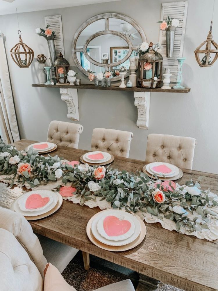 bare wood farmhouse table with boughs of silver dollar eucalyptus and gorgeous roses