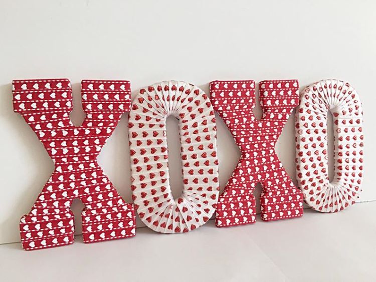 Large pieces for the mantel in the shape of X's and O's covered in heart fabric