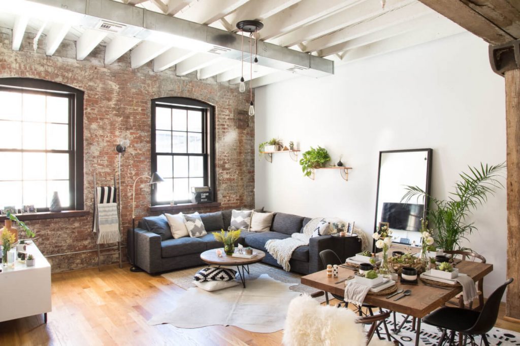 Living room with exposed ceiling beams and exposed brick