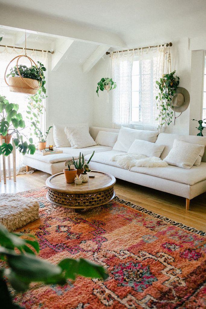 Living room with geometric boho style rug and hanging plants