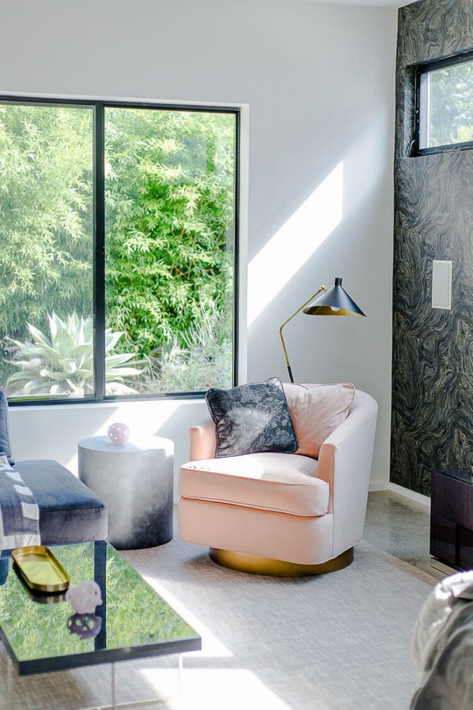 Black and white living room with pink accent chair