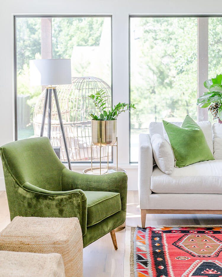 Living room with pink geometric rug and green accent chair