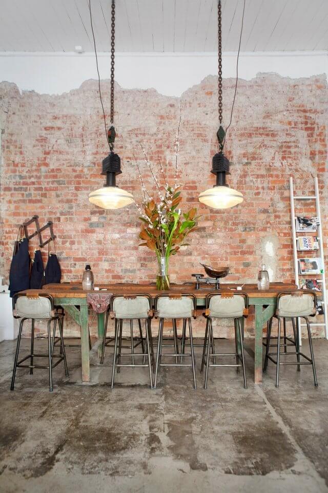 Dining room with exposed brick and industrial farmhouse style lighting