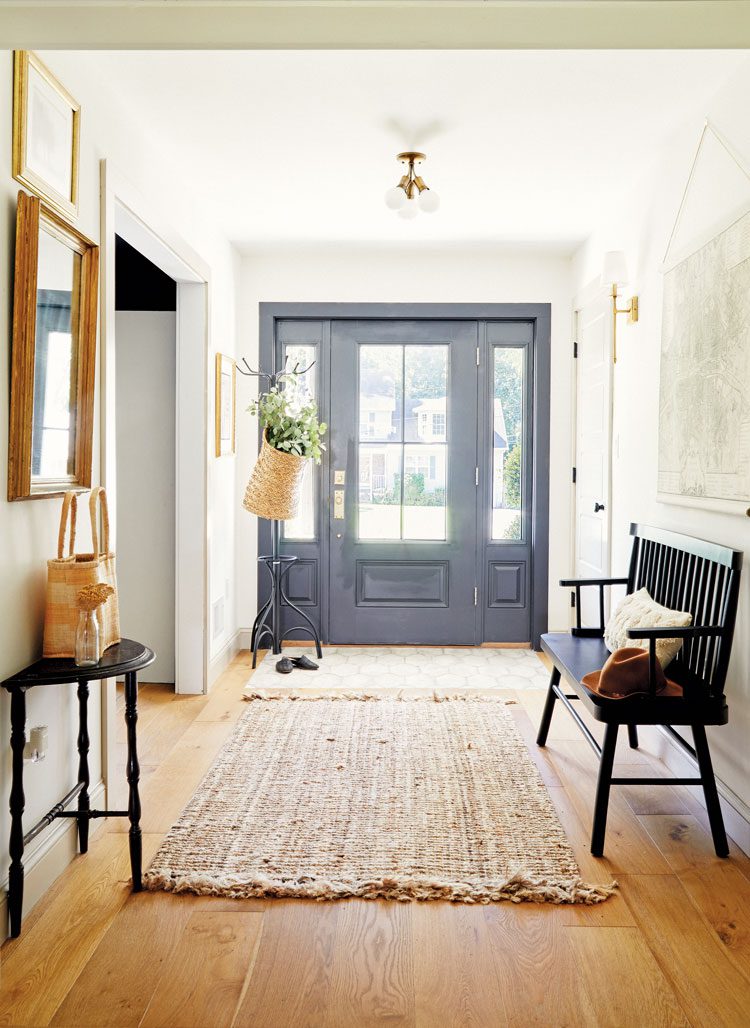 warm wood floors pair with the neutral tones of the room's walls with pops of black color in the furniture