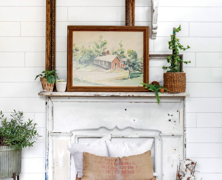 Vintage art on an antique salvage faux fireplace mantle top
