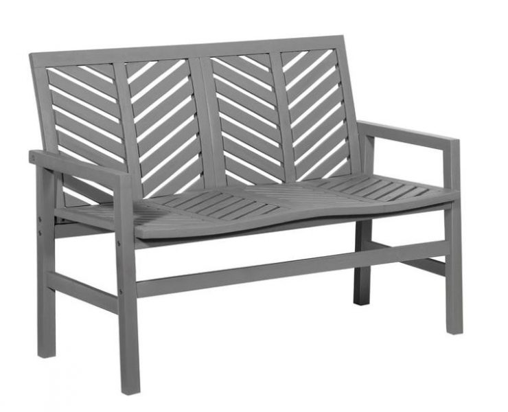 A loveseat bench with a modern twist on farmhouse style with grey paint and a chevron-inspired sleek design