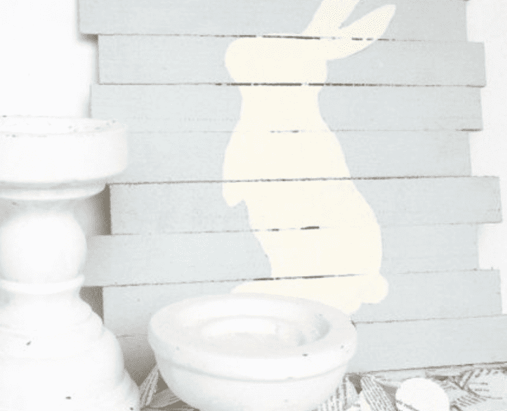 A baby blue pallet wood sign with a white bunny figure