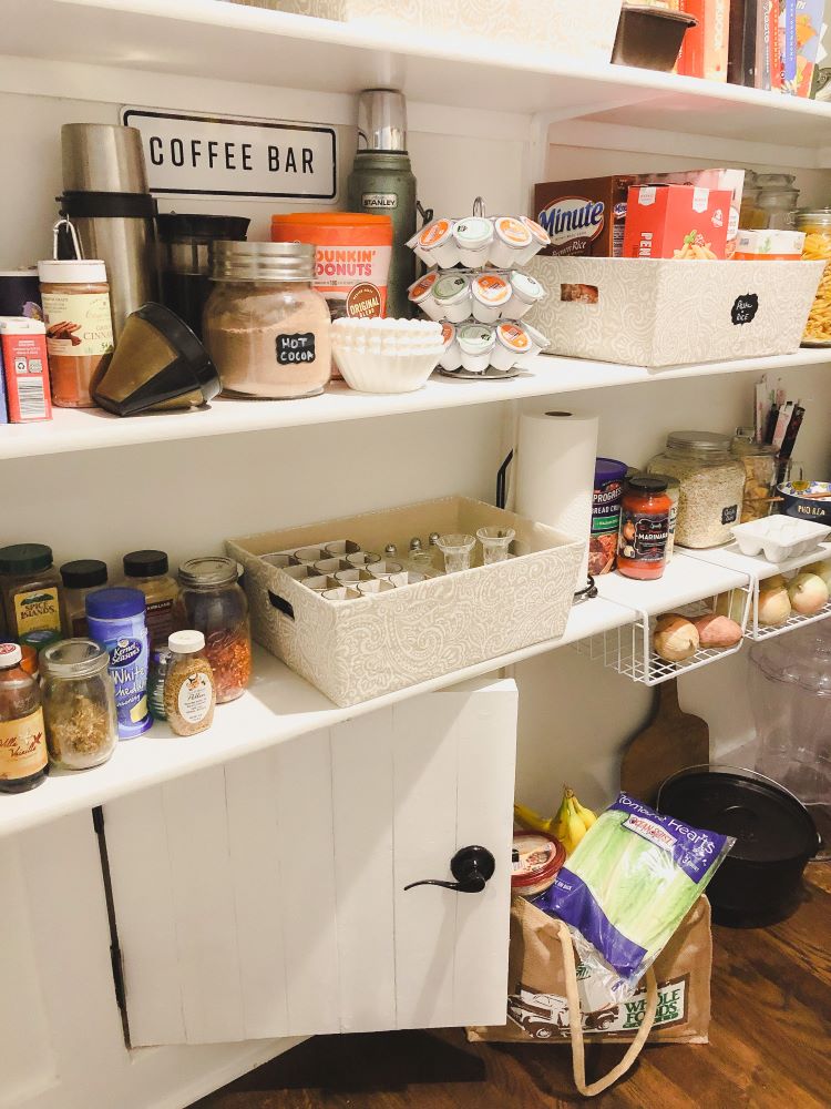 Open shelves in the butler's pantry are covered in many different canned goods