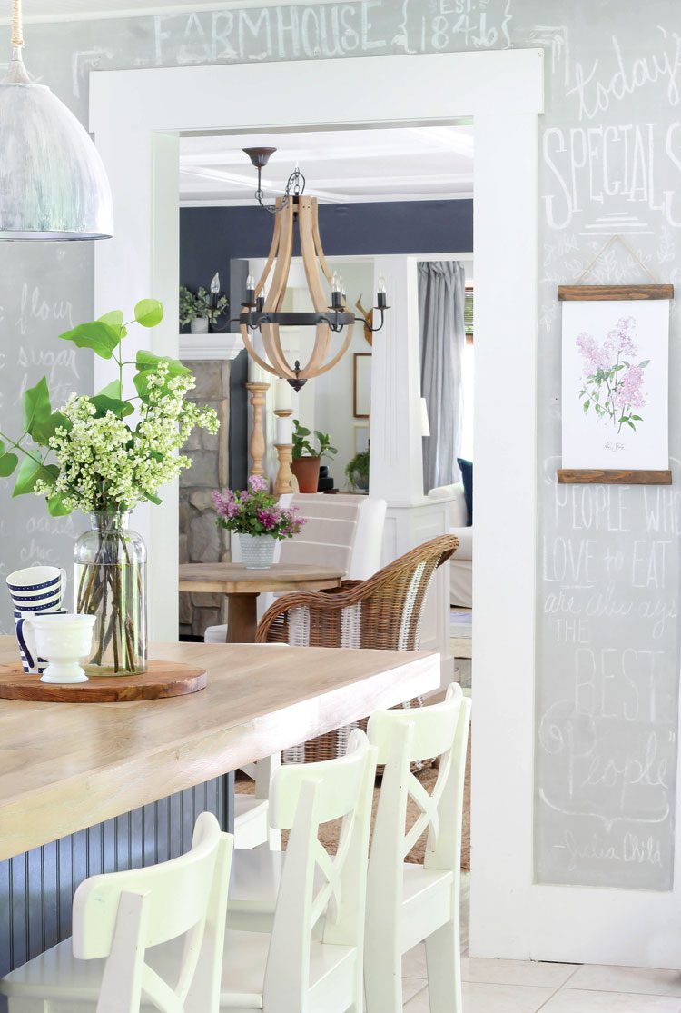 Kitchen to dining room with x backed bar stools and wood island countertop