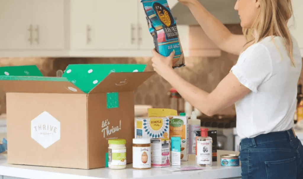 Woman opening a Thrive Market box