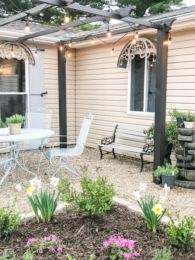 Amy's farmhouse patio has twinkle lights for summer decor