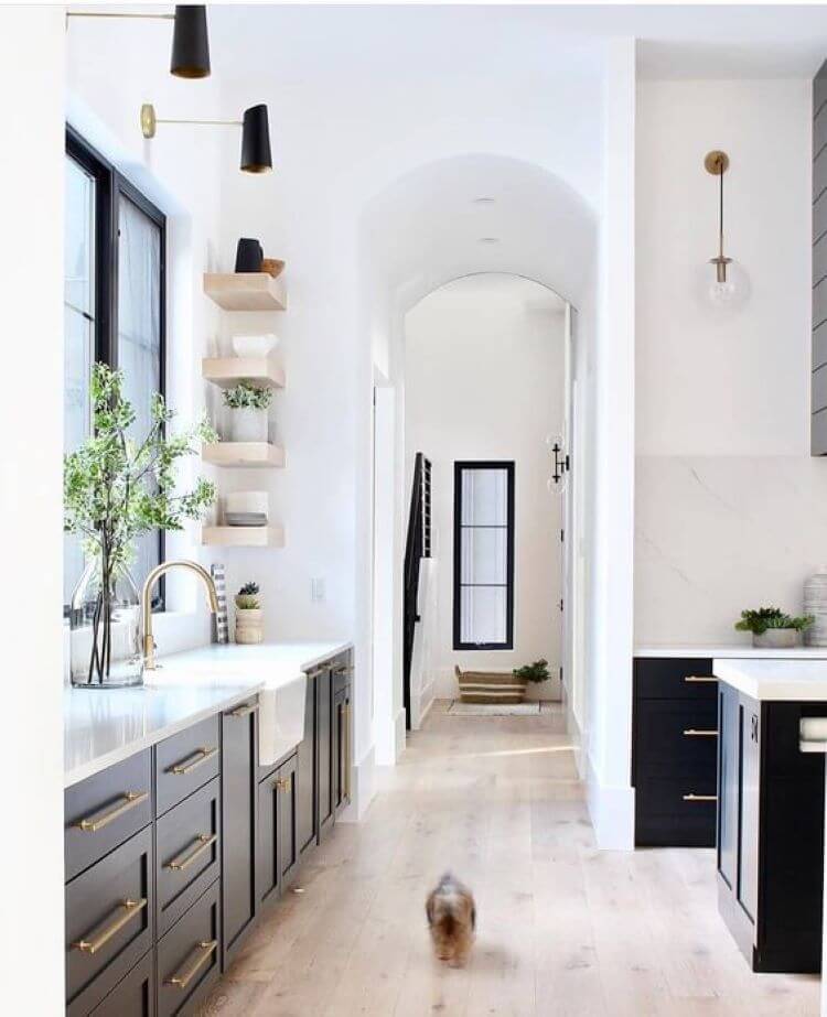 light wood floors in a kitchen with gray counters and cabinets